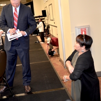 Michael Cuddyer Autographing A Program for Karen Valdez